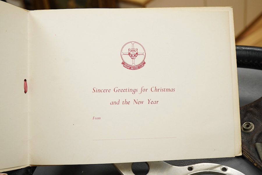 Racing ephemera, including; a Moto-lite steering wheel, a driver's leather cap, an enamelled Le Mans pilot’s radiator badge, signed photograph of Prince Michael Kent standing next to a 12 cylinder single seat racing car